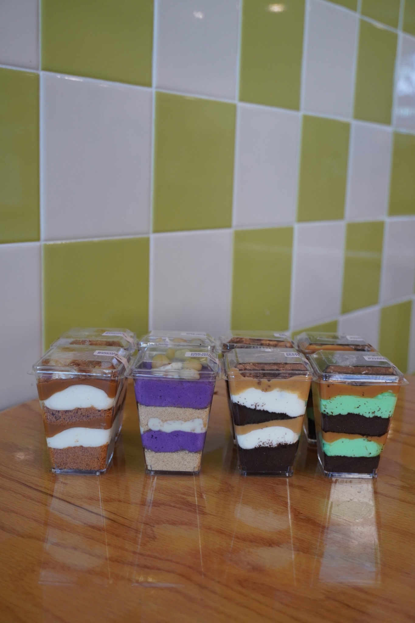 A colorful assortment of Rice Culture layered dessert shooters with lids